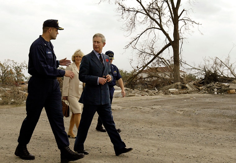 Prince Charles and Camilla walk with U.S. Coast Guard Captain Tom Atkin in the lower 9th Ward in New Orleans Friday. The royal couple spent two hours in the ravaged city, meeting residents and viewing Katrina's damage.