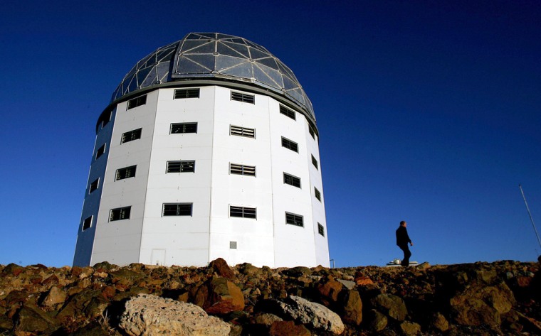 Visitors walk past the dome housing the Southern African Large Telescope perched on a remote and windswept hill in South Africa's arid Karoo region