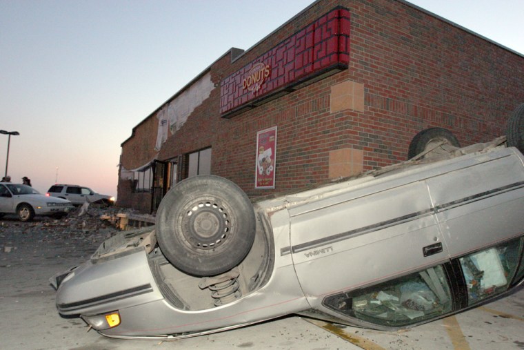 An overturned car sits in the parking lot of Casey's General Stores in Woodward, Iowa, after a tornado struck the town Saturday, Nov. 12, 2005. Tornadoes swept across central Iowa on Saturday, damaging homes and buildings and forcing college football fans to take shelter in a nearby basketball arena. (AP Photo/Kevin Sanders)