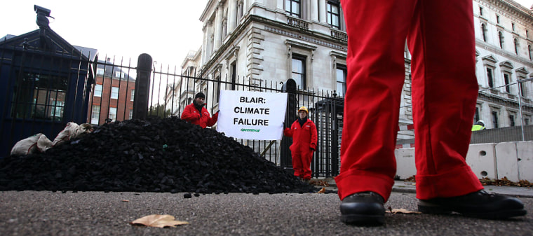 Greenpeace protesters hold demonstration after dumping coal at the rear entrance of Downing Street in London
