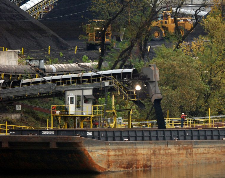 Workers at Kanawha River Terminals fill a coal barge on the Kanawha River in Quincey, W.Va. earlier this month.