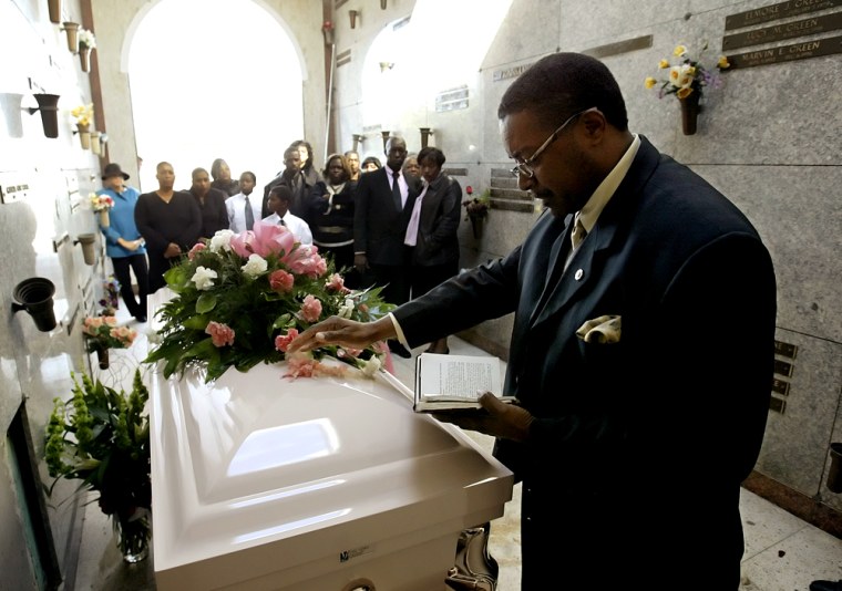 Rev. Carl Johnson Sr. reads a prayer over the casket of Ethel Mayo Freeman, 91, as family and friends attend services at Mount Olive Cemetery in New Orleans on Wednesday. Freeman became an anonymous symbol of the government's slow response to Hurricane Katrina died at the New Orleans Convention Center in the aftermath of the hurricane.