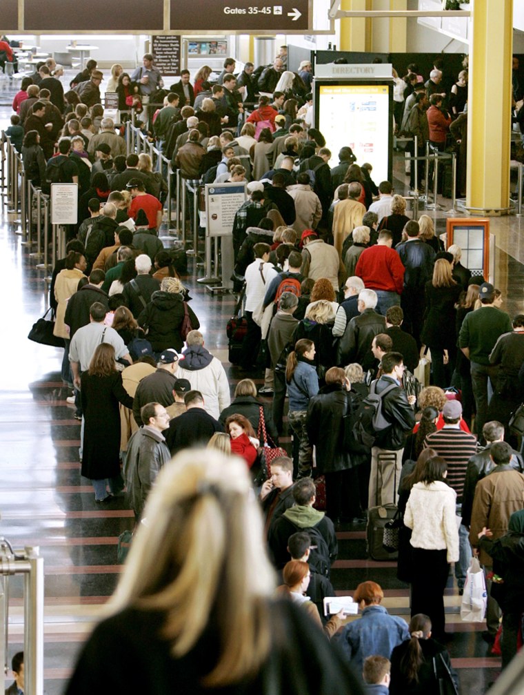 Christmas Eve travelers wait to pass through security at Reagan National Airport