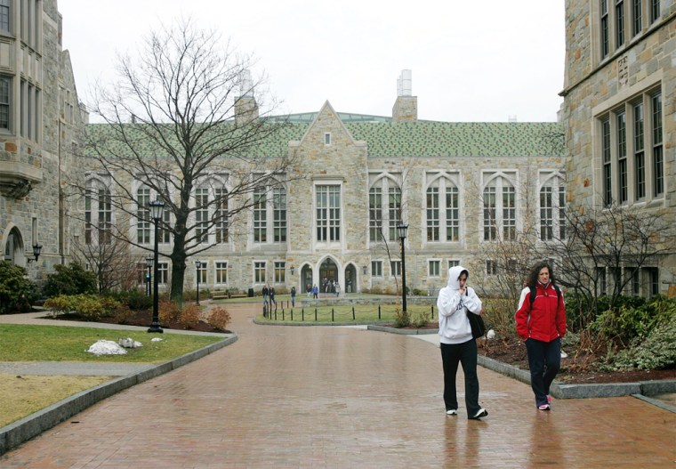 Boston College students walk across campus in Boston earlier this year. Roughly 40 percent of those who start a four-year program still have not earned a degree after year six, although students at private colleges fare somewhat better.