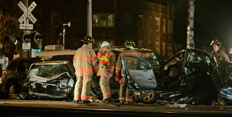 Firemen examine vehicles struck by a commuter train during the holiday rush hour in Elmwood Park, Ill., on Wednesday.