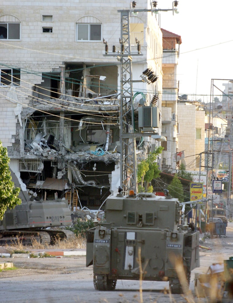 An Israeli armoured vehicle drives towar