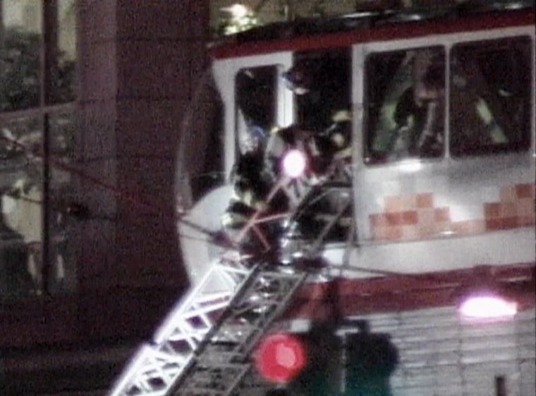 Seattle firefighters help passengers evacuate the city's monorail after two trains collided Saturday night.
