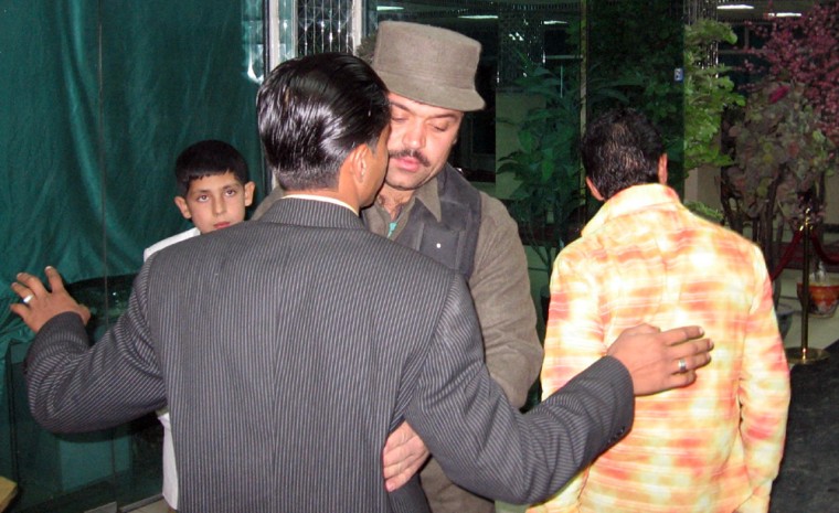SLUG: Afghanistan/Afghan   INPUTDATE: 2005-11-27 11:36:08.350   CREDIT: Griff Witte/FROM_PHOTOPOST/TWP  LOCATION: Kabul, , Afghanistan  CAPTION: Afghan National Police officer Ghulam Raza, 26, frisks guests as they arrive for a wedding at the Sham-e-Paris restaurant in Kabul.   Sent by: Griffin Witte   Photo Editor: