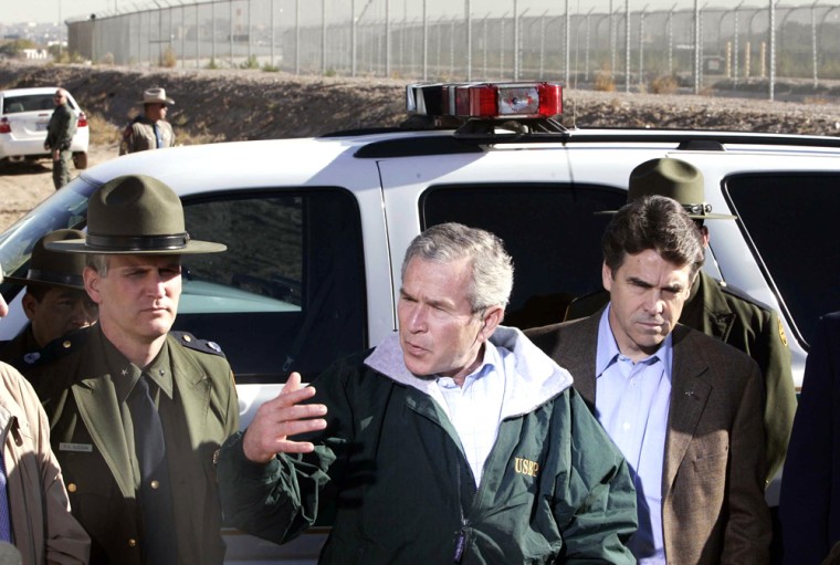 US President Bush speaks in front of fence separating Mexico and US in El Paso