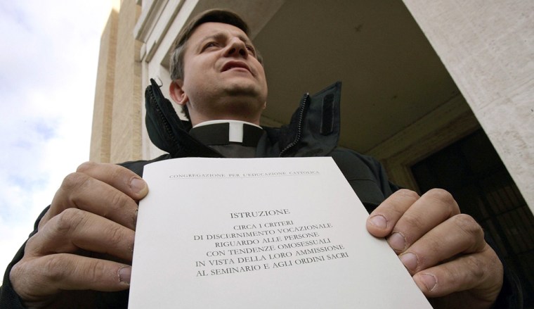 Polish priest Cielecki shows the official Vatican document released from the Holy See press office in Rome