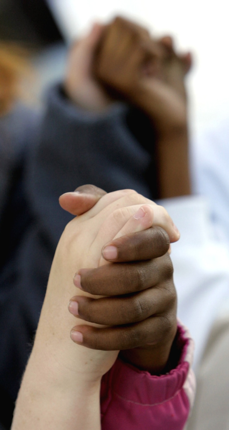 White and black children hold hands and sing during a program honoring the 50th Anniversary of the Montgomery Bus Boycott on the steps of the Capitol, Thursday Dec. 1, 2005, in Montgomery, Ala. Rosa Parks, a black woman, was arrested Dec. 1, 1955, for refusing to give up her seat to a white man. (AP Photo/Rob Carr)