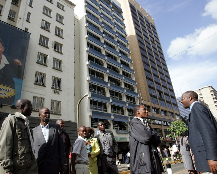 Kenyans gather outside office buildings in Nairobi on Monday after evacuating due to the earthquake.