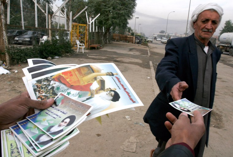 An Iraqi man distributes election pamphlets for the Shiite list United Iraqi Alliance showing Shiite cleric Grand Ayatollah Ali al-Sistani in Baghdad, Iraq, on Tuesday.