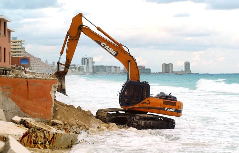 A bulldozer cleans up a Cancun beach on Monday as the Mexican resort city tries to recover from Hurricane Wilma.