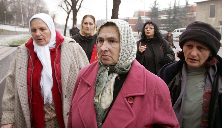 Family members of Bosnian muslim men and boys whose execution was captured on videotape arrive Tuesday at the Special Court building in Belgrade, Serbia and Montenegro. The landmark trial of five Serb militiamen charged with the videotaped execution of six Bosnian Muslim civilians in 1995 opened in Belgrade Tuesday. 