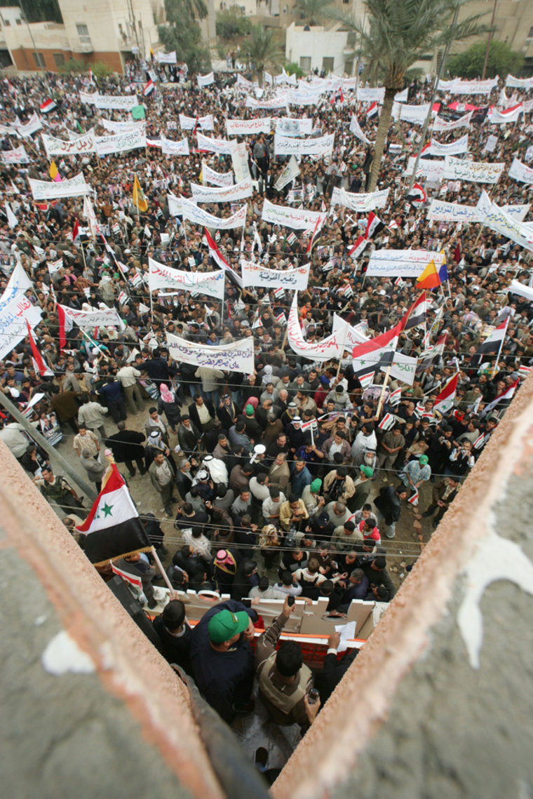 Iraqis demonstrate outside the Omar al-M