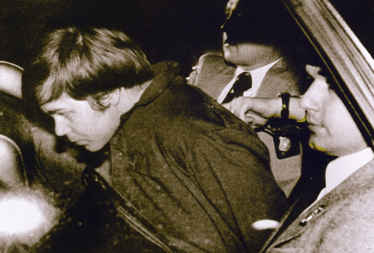 John Hinckley Jr. (L) escorted by police in Washington, DC, on March 30, 1981 after he shot and seriously wounded President Ronald Reagan.