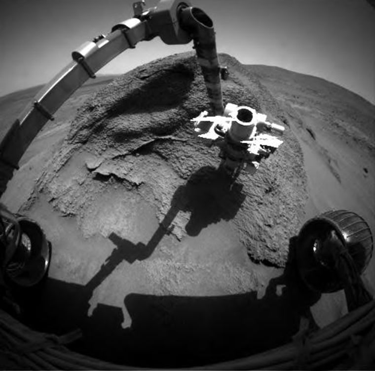 NASA's Spirit rover points its instrument-laden robotic arm toward an outcropping in the Columbia Hills nicknamed "Comanche Spur," the focus of Spirit's study as it approaches the two-year mark on Mars.