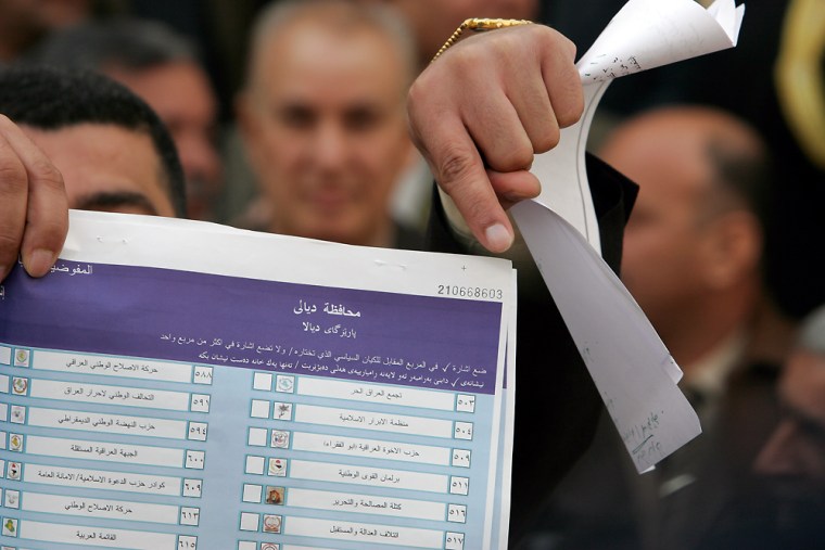 A member of the Maram coalition of 48 political entities, which opposes the results of the Dec. 15. elections, holds a ballot paper that the group claims is fake, at a Tuesday press conference in Baghdad, Iraq.