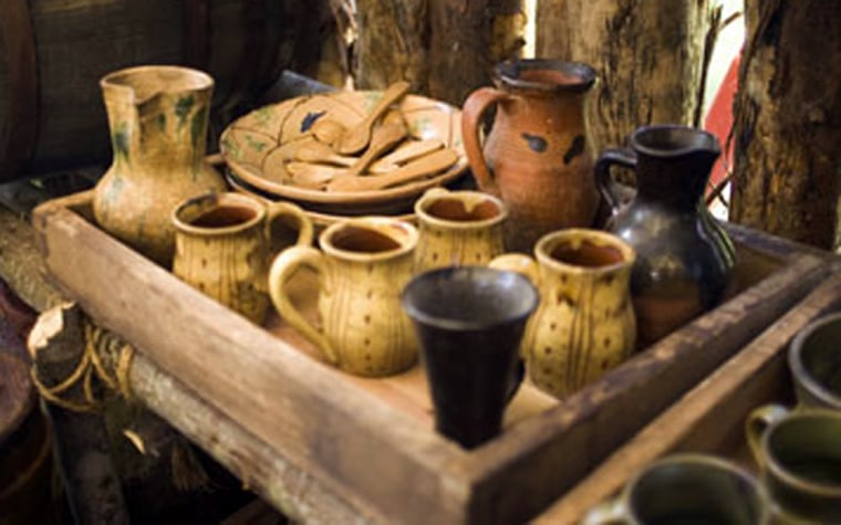 Re-creations of cups and pitchers from the Jamestown Settlement's early days are displayed on a set for "The New World," a Hollywood epic about the colony.