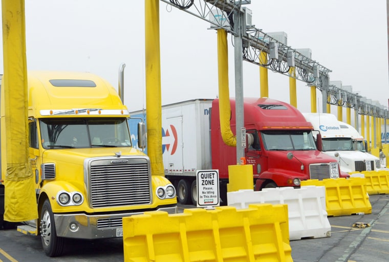 Long yellow hoses deliver the IdleAire Technologies system into rigs at a truck stop in Knoxville, Tenn. The systems provide heat, air conditioning, TV and Internet access to truckers who can rest with their engines off.