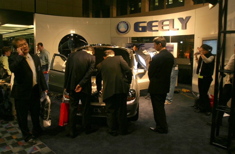 U.S. and foreign journalists crowd the small Geely exhibit at Cobo Center in Detroit. The exhibit was in the entrance to the Auto Show rather than on the main floor with almost all of the other exhibitors.