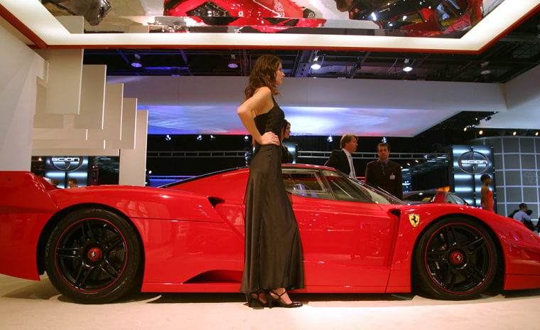 Model Yuliya poses next to a $2 million Ferrari FXX. It’s hard on her feet, she says, but standing next to a big Ferrari’s worth it.