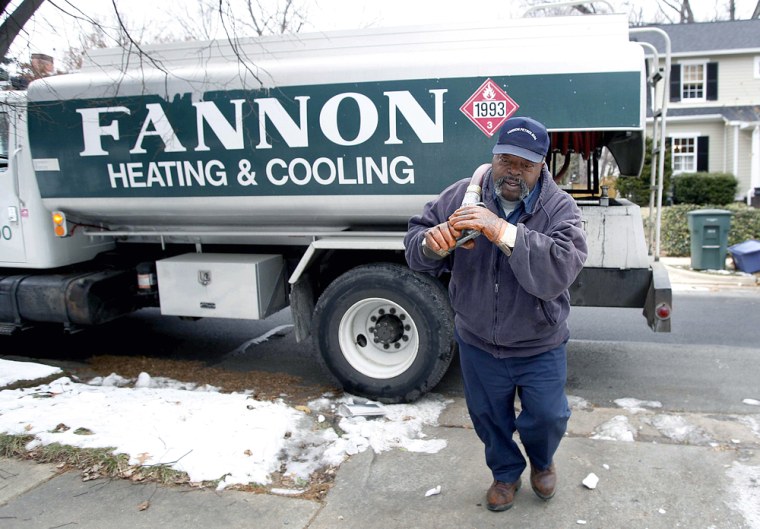 Man prepares to deliver heating oil to a house in Alexandria
