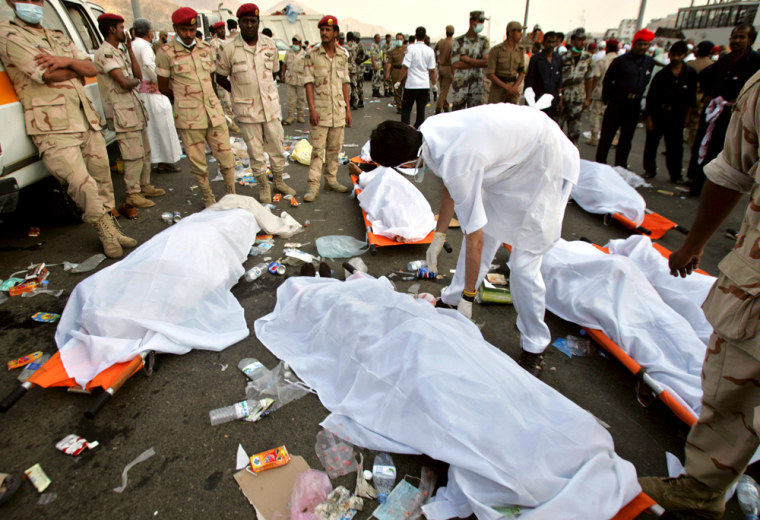 Saudi security officers cover the bodies of victims of Thursday's stampede in Mina, Saudi Arabia.