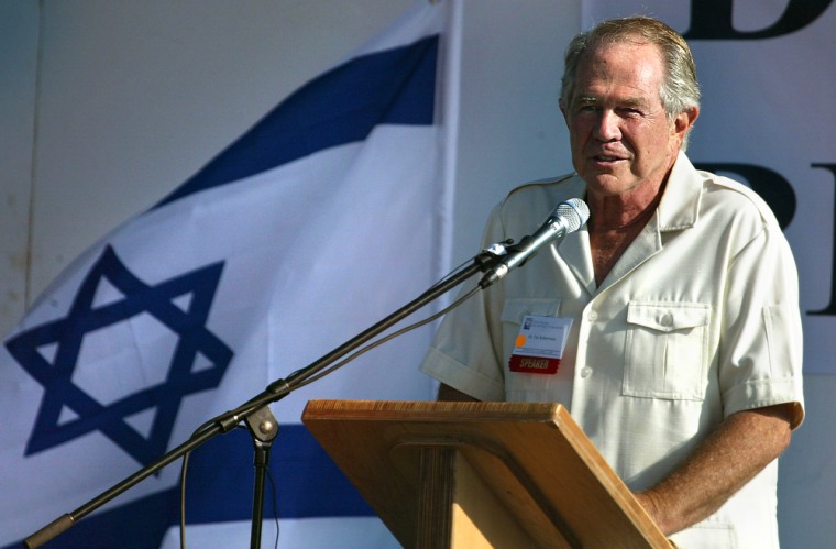 Televangelist Pat Robertson, backed by an Israeli flag, speaks to evangelical Christians during a pilgrimage to Israel in October 2004. His comments about the cause of Prime Minister Ariel Sharon's stroke have drawn widespread condemnation by other Christian leaders.