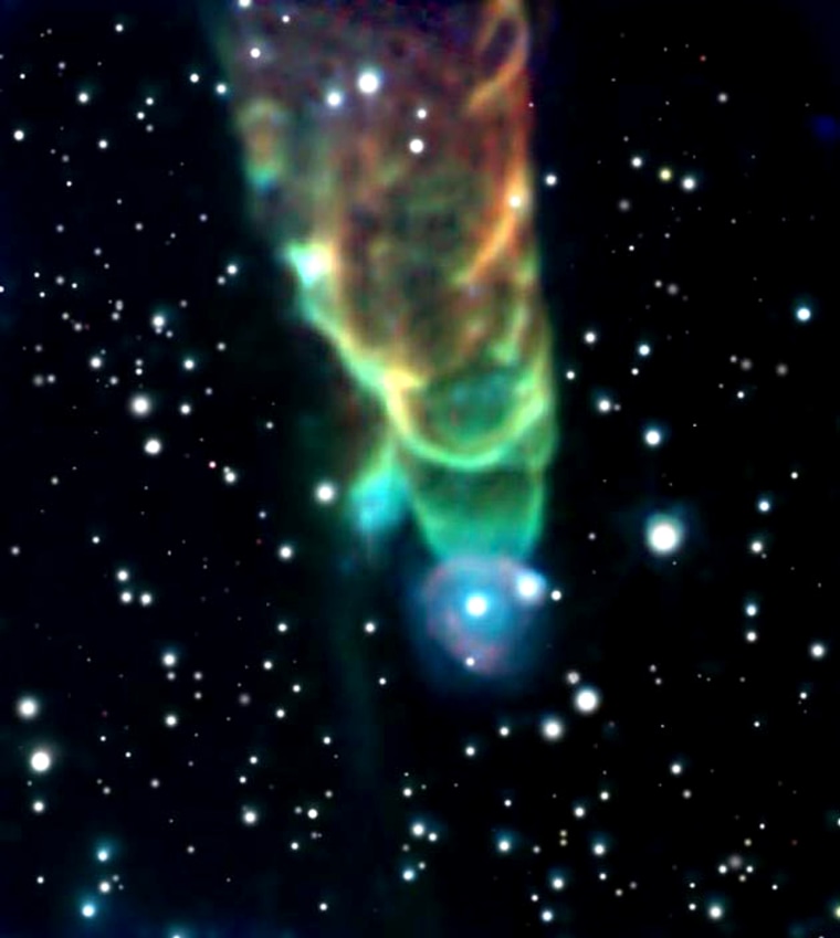 This color-coded image shows high-energy particles whirling out in a spiral pattern from a young star that is located out of the frame, above the top edge. Scientists aren't yet sure whether the bright star near the bottom of the "tornado" is actually associated with the spiral structure.