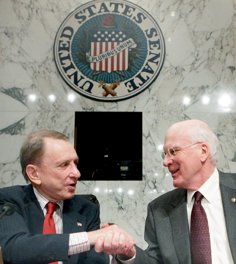 US Judiciary Committee Chairman Specter shakes hands with Leahy at conclusion of hearings on Capitol Hill in Washington