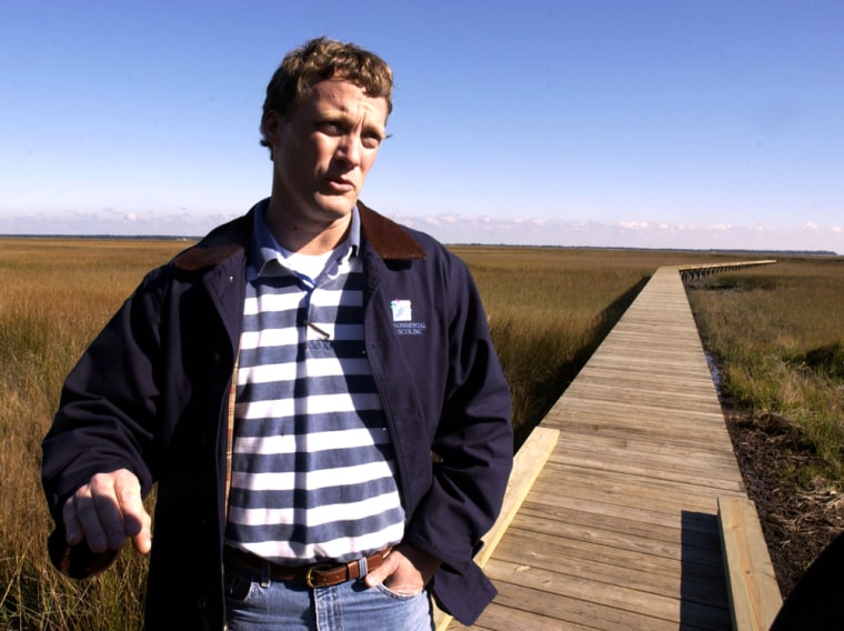 Michael DeMell, environmental consultant to Cumberland Harbour development, stands on a newly constructed dock that comes off a deep water lot in St. Marys, Ga. The marina and housing development takes up part of a peninsula frequented by northern right whales.