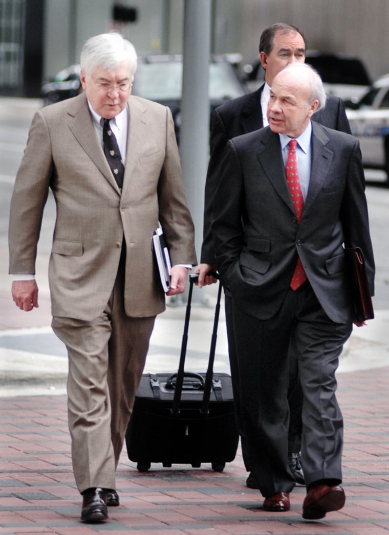 Former CEO of Enron, Kenneth Lay, talks to his attorney Mike Ramsey while on their way to the Houston Federal Courthouse