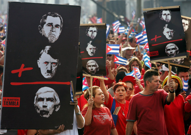 Cuban carry signs depicting US President Bush Hitler and Posada during a protest march in Havana