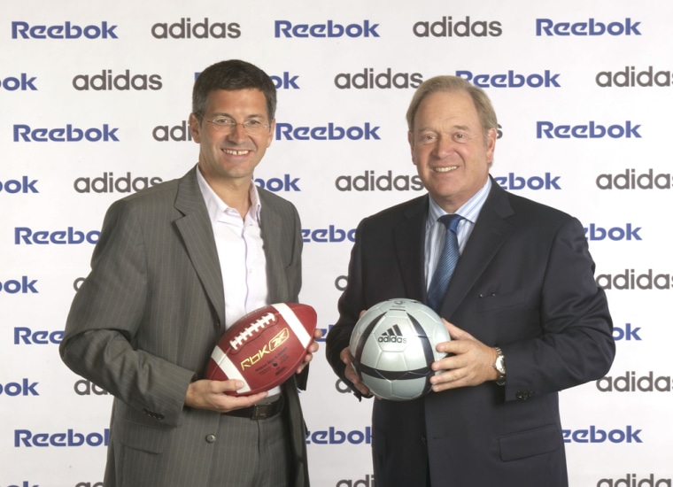 Reebok Chairman and CEO Paul Fireman, left, and Adidas Chairman and CEO Herbert Hainer are photographed last year. Adidas-Salomon AG received regulatory approval to take over Reebok International Ltd., creating an even bigger rival to Nike.