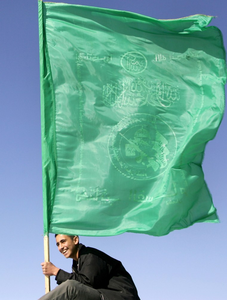 A Hamas supporter waves the movement's f