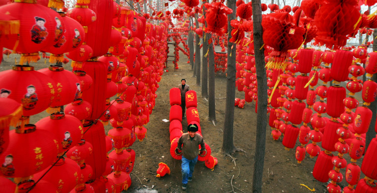 Chinese workers prepare red lanterns to celebrate upcoming Spring Festival at park in Zhengzhou