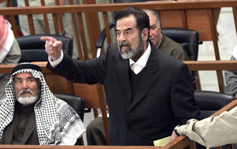 Former Iraqi president Saddam Hussein chastises the court moments after his half brother, Barzan Ibrahim was forcibly removed from the trial held in Baghdad's heavily fortified Green Zone on Sunday.