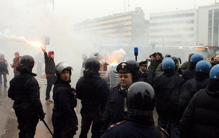 Riot police in Venice respond to demonstrators who held a protest as the 2006 Winter Olympics torch passed through the Italian city on Jan. 17. The protests were upset about a plan to save the sinking city from high waters.