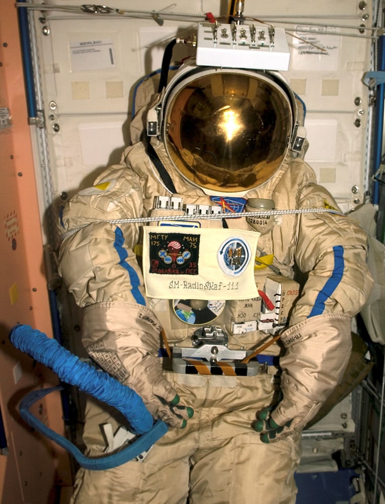 An old Russian Orlan spacesuit is photographed in the Unity node of the International Space Station, which will be released by hand from the space station during a spacewalk Feb. 3, 2006. Outfitted with a special radio transmitter and other gear, the spacesuit comprises a Russian experiment called SuitSat. It will fly free from the station as a satellite in orbit for several weeks of scientific research and radio tracking, including communications by amateur radio operators. Eventually, it will enter the atmosphere and be destroyed.