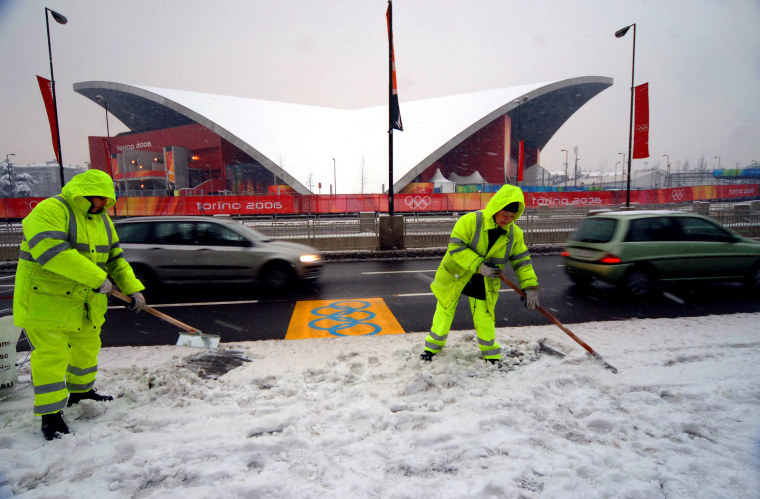 Workers clear the area in front of the Palavela arena in Turin, Italy on Jan. 28. The Palavela is the venue hosting the figure skating and short track speed skating events of the Turin 2006 Winter Olympics.