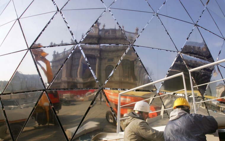Workers put the finishing touches on a large reflective globe at the Medal Plaza in Turin, Italy. The Plaza will be used for the presentation of Olympic medals, and music concerts which will be held during the upcoming Turin 2006 Winter Olympics. 