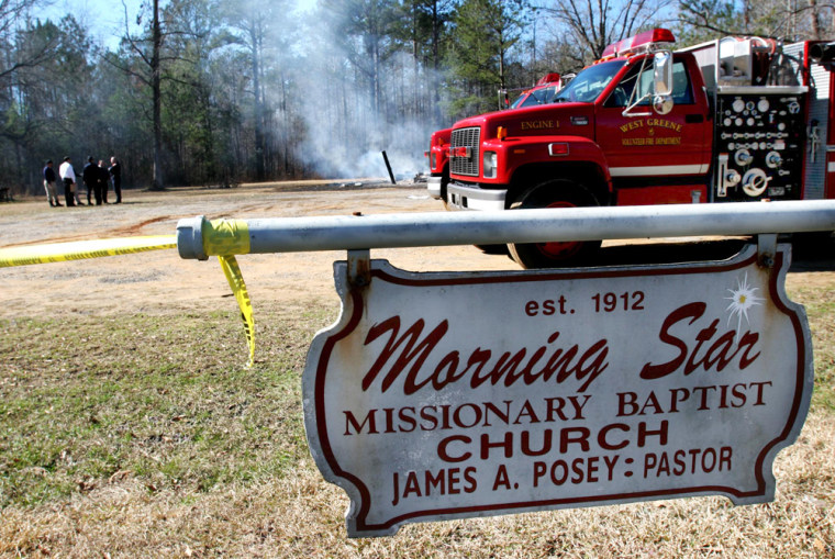 Investigators work Tuesday at the scene of a fire at the Morning Star Missionary Baptist Church near Boligee, Ala.