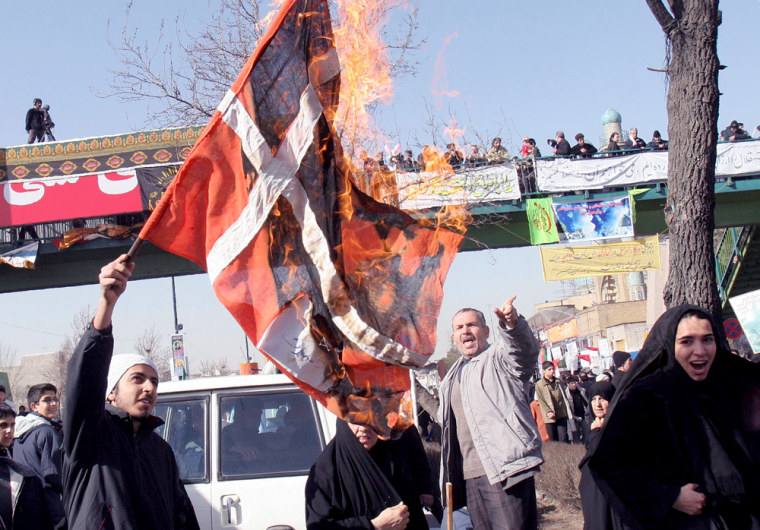 Iranian protesters burn a Danish flag during a demonstration on Saturday.