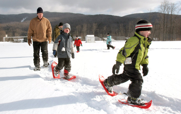 Aaron Loukes, left, a gym teacher at Lin-Wood Elementary School in Lincoln, New Hampshire, holds a first grade class outside and on snowshoes.