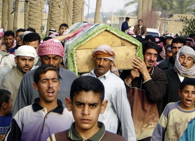 Iraqi Sunni residents carry the coffin of a man during a funeral in Ramadi