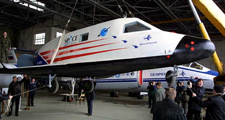 A mockup of the C-21 suborbital spaceship is displayed for a Russian photo opportunity. Space Adventures says the C-21 concept has been updated for development as the Explorer spacecraft.