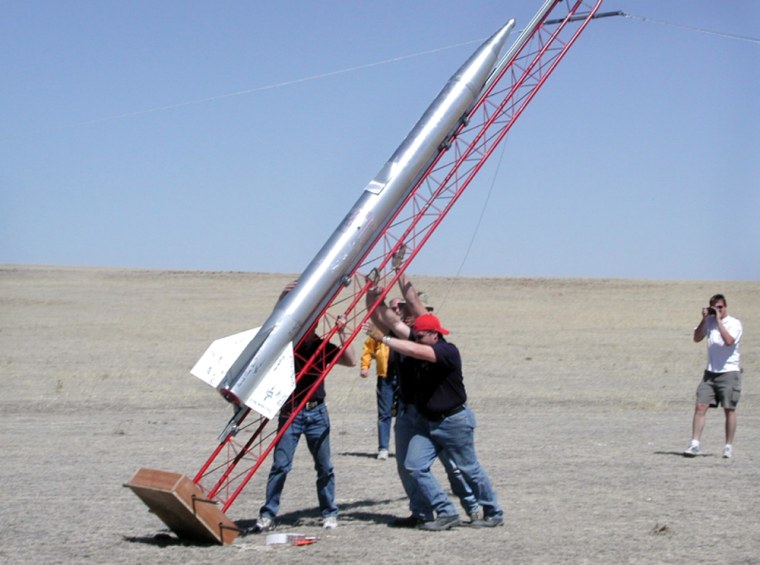 Rocketeers prepare for the liftoff of Beyond-Earth Enterprise's Launch Craft 1 in April 2004. Another rocket is due to send personal "DNA kits" on a brief flight in October.