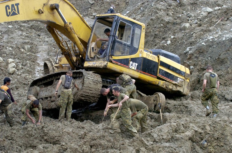 US Marines dig out a backhoe that got st